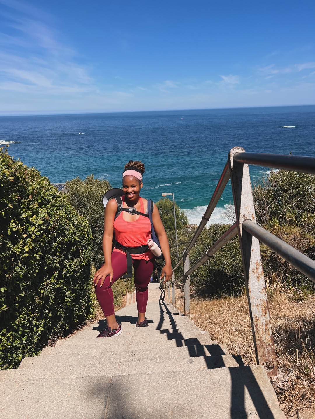 Sandra, postpartum fitness coach, walking stairs with her baby